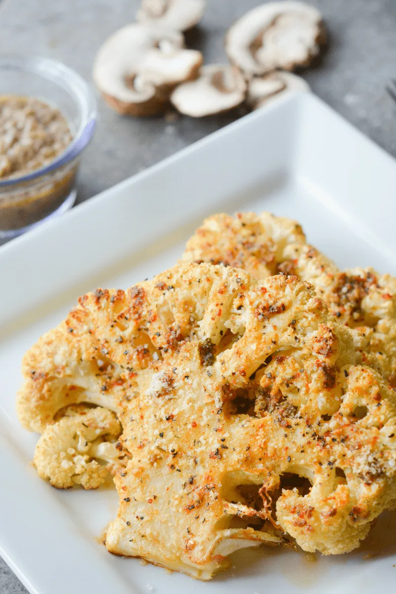 This Parmesan Cauliflower Steak is an amazing vegetarian meal to satisfy your taste buds and make your tummy smile! | heyketomama.com