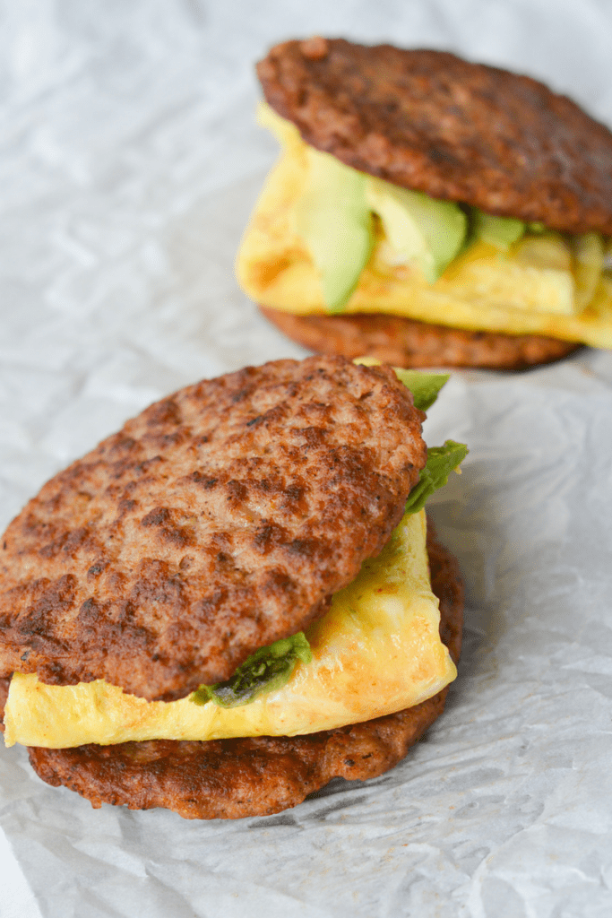 My favorite keto breakfast sandwich is low in carbs, high in healthy fats and off the charts in flavor! The sausage on the outside is the perfect touch to make you not miss the bread at all! | heyketomama.com