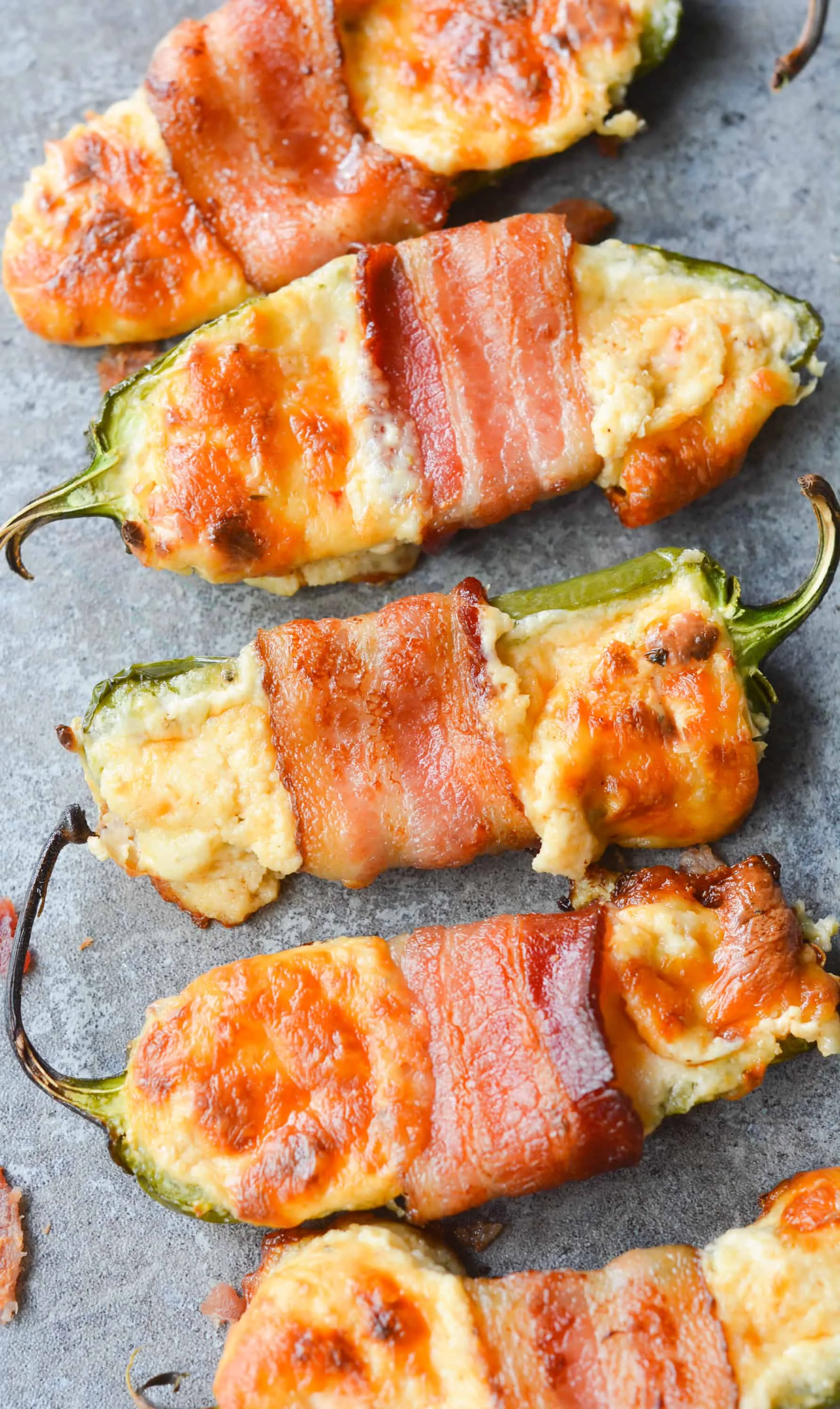 These Bacon Wrapped BBQ Jalapeno Poppers are an incredibly savory, flavorful low carb dish. Perfect to bring to any backyard BBQ, or to just enjoy at home! | heyketomama.com