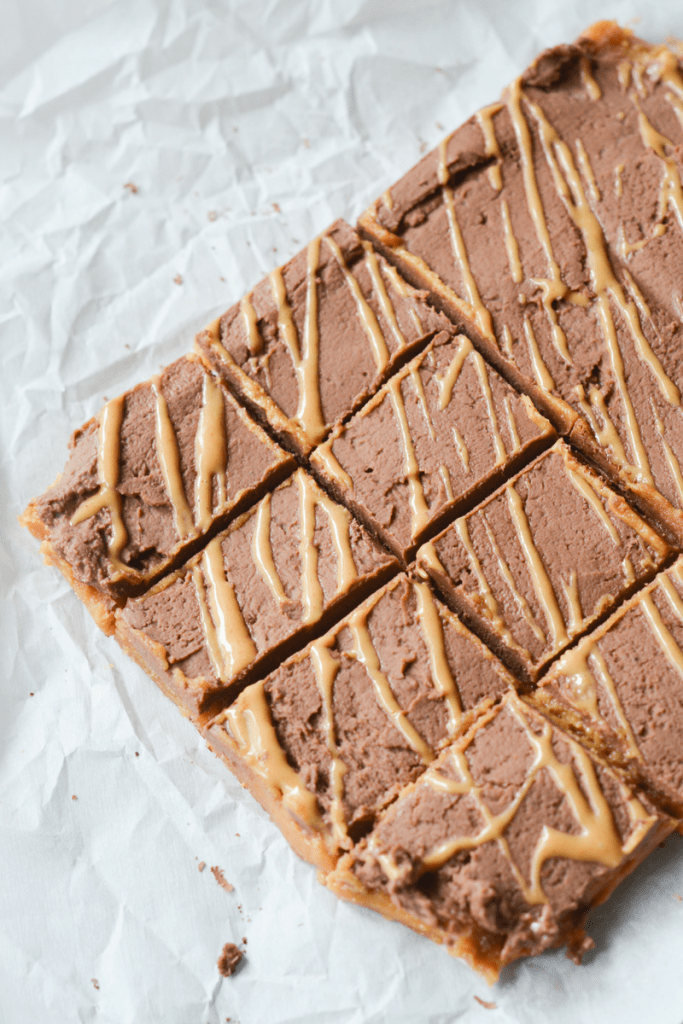 These Keto Chocolate Peanut Butter Fudge Bars are an easy to make indulgence that will satisfy your sweet tooth in a guilt free way.  | heyketomama.com