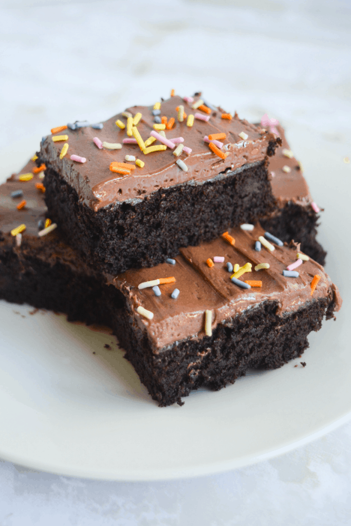 stack of keto brownies covered in sprinkles on a white plate