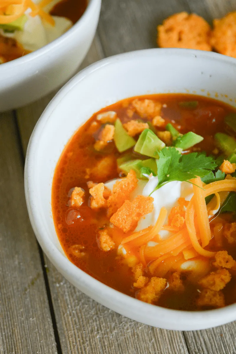 This Keto Chicken Taco Soup is your answer when the colder months ask what delicious dish you'll be warming yourself up with! It's easy, delicious, and full of low carb goodness! | heyketomama.com