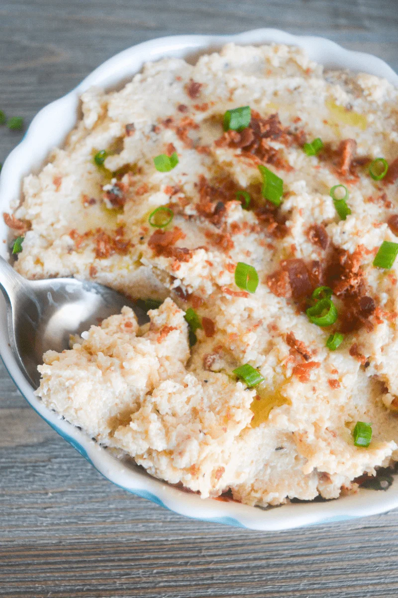 This Keto Mashed Cauliflower is the perfect low carb side dish for a hearty meal. Whether that's a savory companion for your Thanksgiving Dinner, or a flavorful side for your baked Chicken Thighs! | heyketomama.com