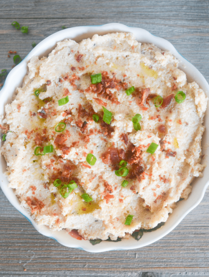 This Keto Mashed Cauliflower is the perfect low carb side dish for a hearty meal. Whether that's a savory companion for your Thanksgiving Dinner, or a flavorful side for your baked Chicken Thighs! | heyketomama.com