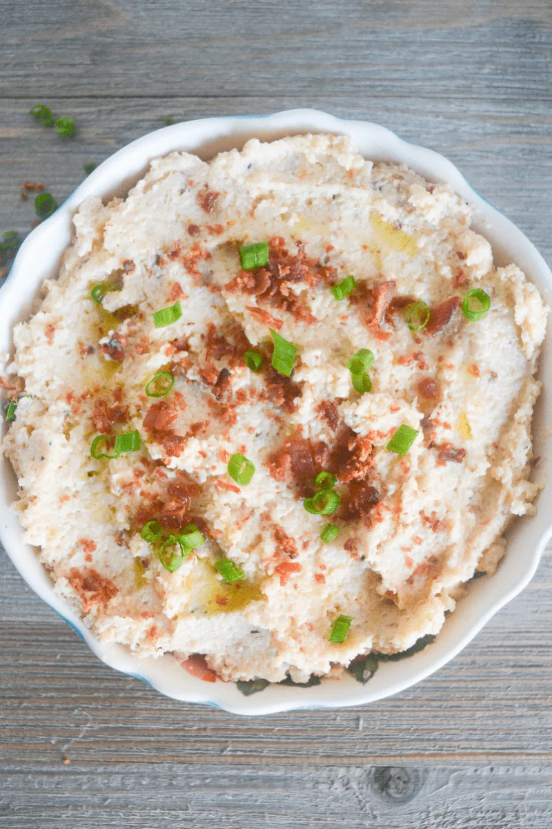 This Keto Mashed Cauliflower is the perfect low carb side dish for a hearty meal. Whether that's a savory companion for your Thanksgiving Dinner, or a flavorful side for your baked Chicken Thighs! | heyketomama.com