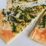 keto spinach pesto flatbread slices on a white background