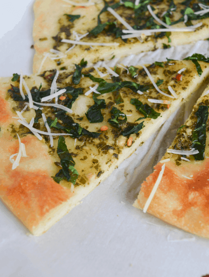 keto spinach pesto flatbread slices on a white background