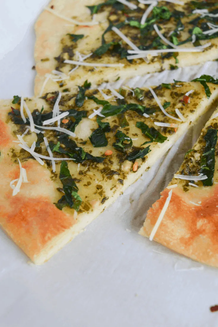 keto spinach pesto flatbread slices on a white background