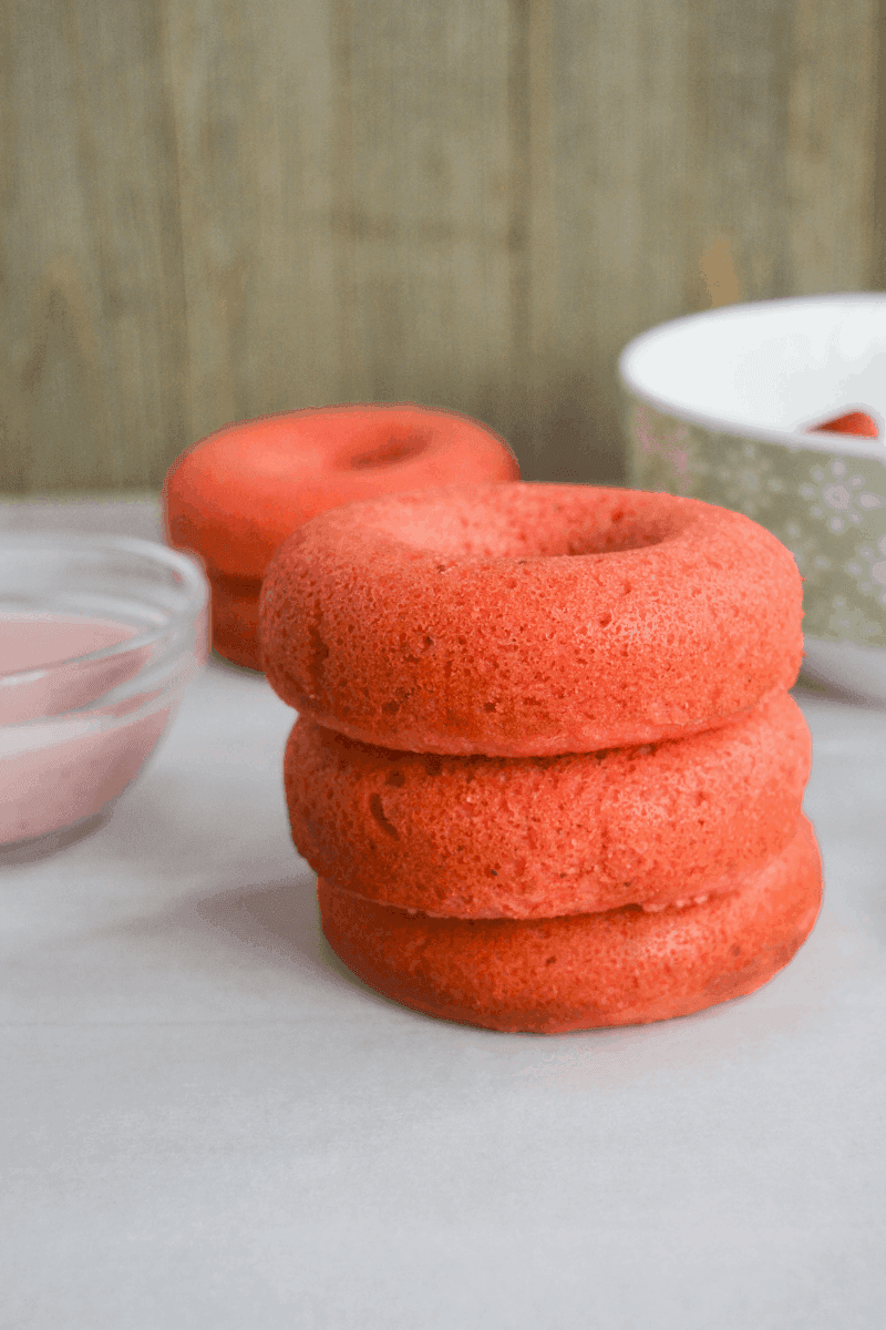 three stacked unglazed keto strawberry donuts