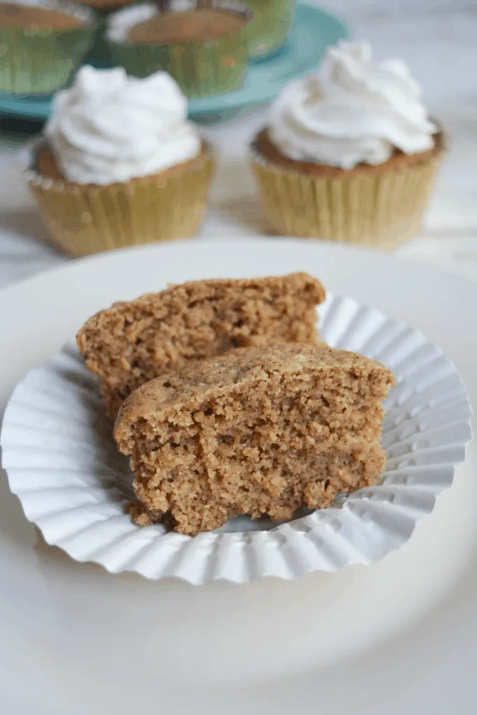 One Muffin, cut in half to show texture on a white plate