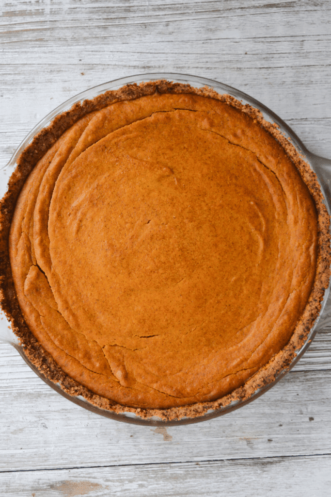 full keto pumpkin pie in glass pie dish
