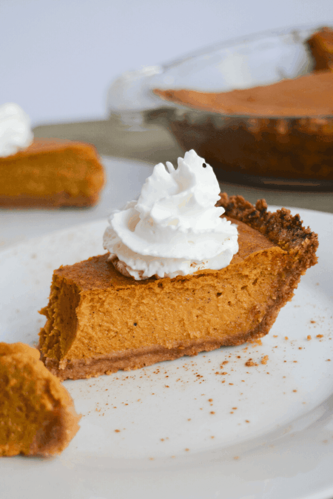 slice of keto pumpkin pie with a dollop of whipped cream on top