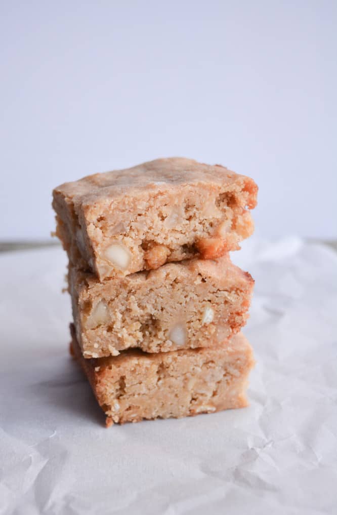 stack of three keto blondies on a piece of parchment paper
