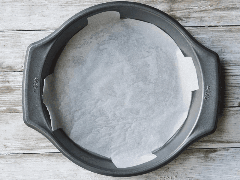 cake pan with a piece of parchment paper fitted inside of it