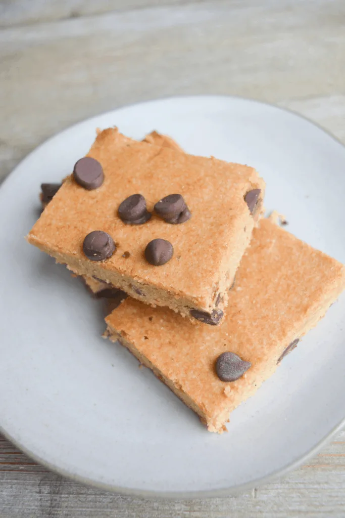 keto chocolate late chip cookie bars sitting on a white plate