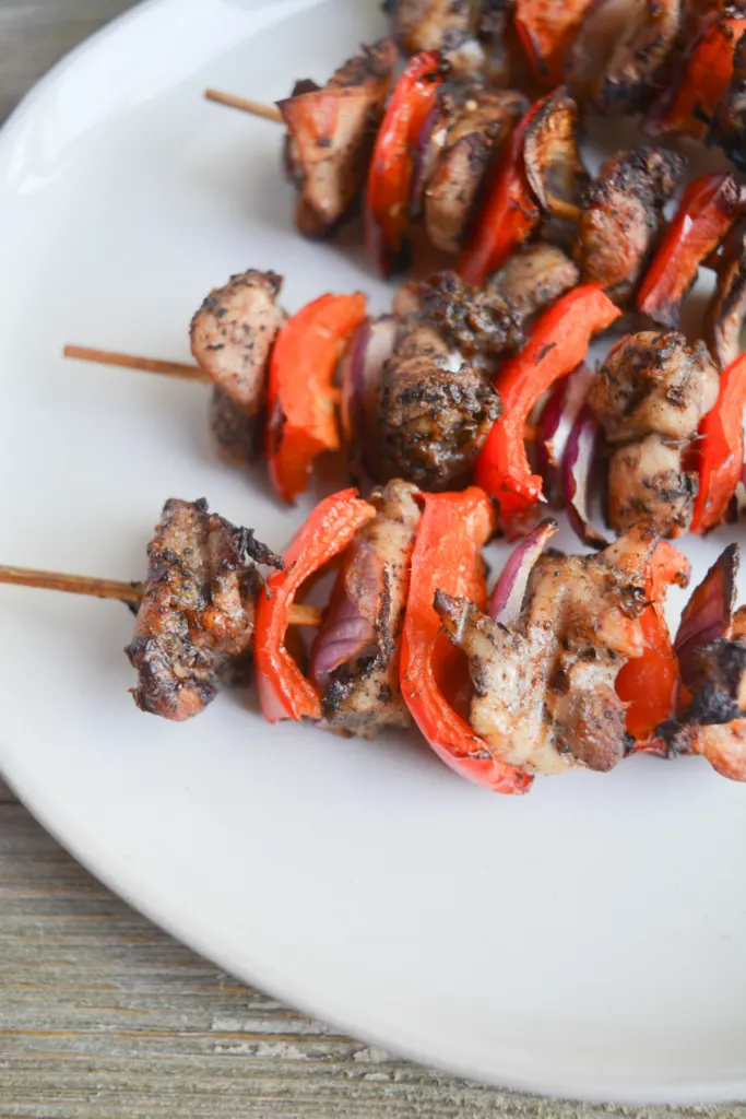 air fryer chicken kebabs sitting on a white plate