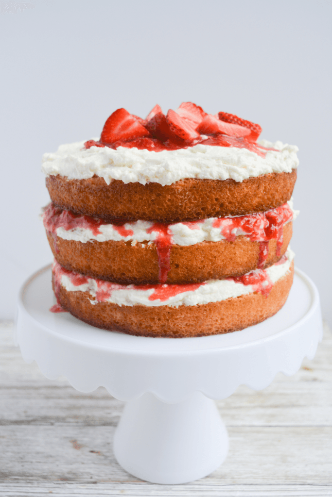 keto strawberry shortcake layer cake with whipped frosting and strawberry jam