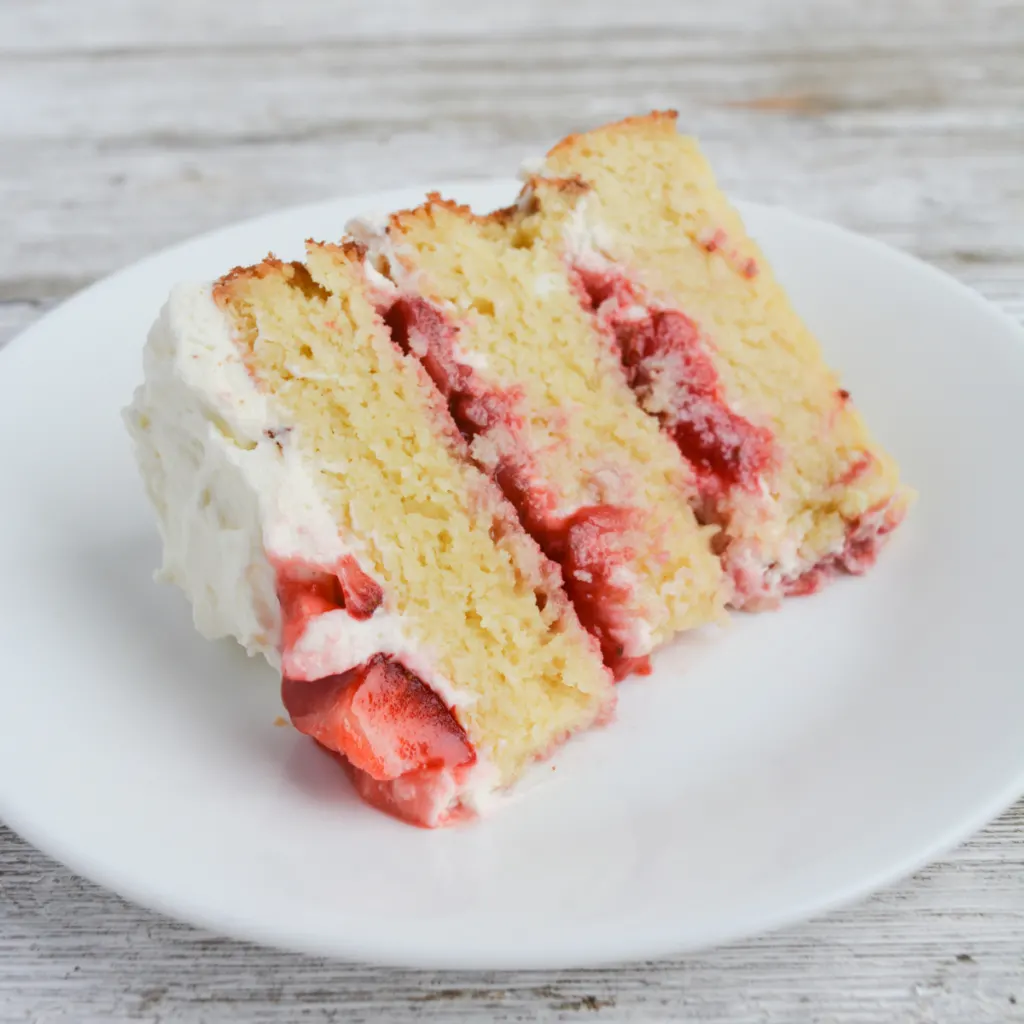 slice of strawberry shortcake cake on a white plate