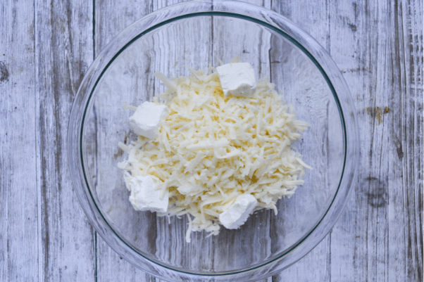 step one of making keto friendly fathead dough: melting the mozzarella cheese and cream cheese