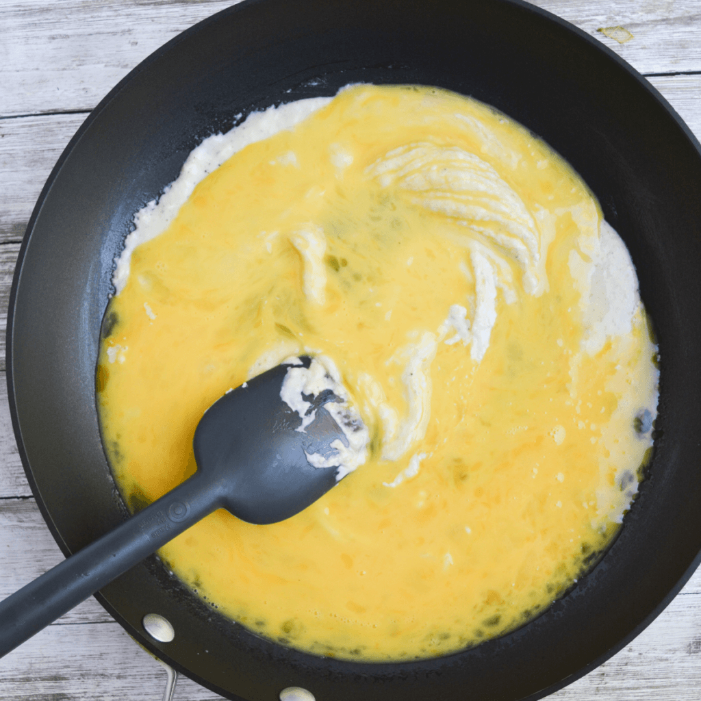 fluffy parmesan scrambled eggs step two: adding the whisked eggs and stirring