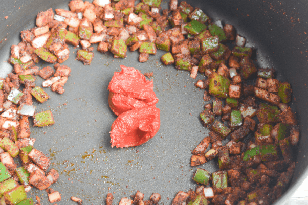 step four for cooking low carb chili: adding the veggies to the spices