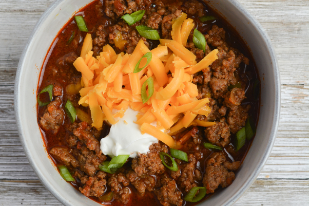 step six for cooking low carb chili: serving the chili with toppings of choice