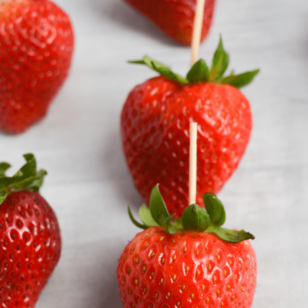 keto chocolate covered strawberries step one: place toothpicks in strawberries