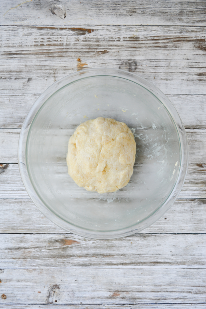 ball of fathead dough in a bowl, ready to be pressed out and baked.
