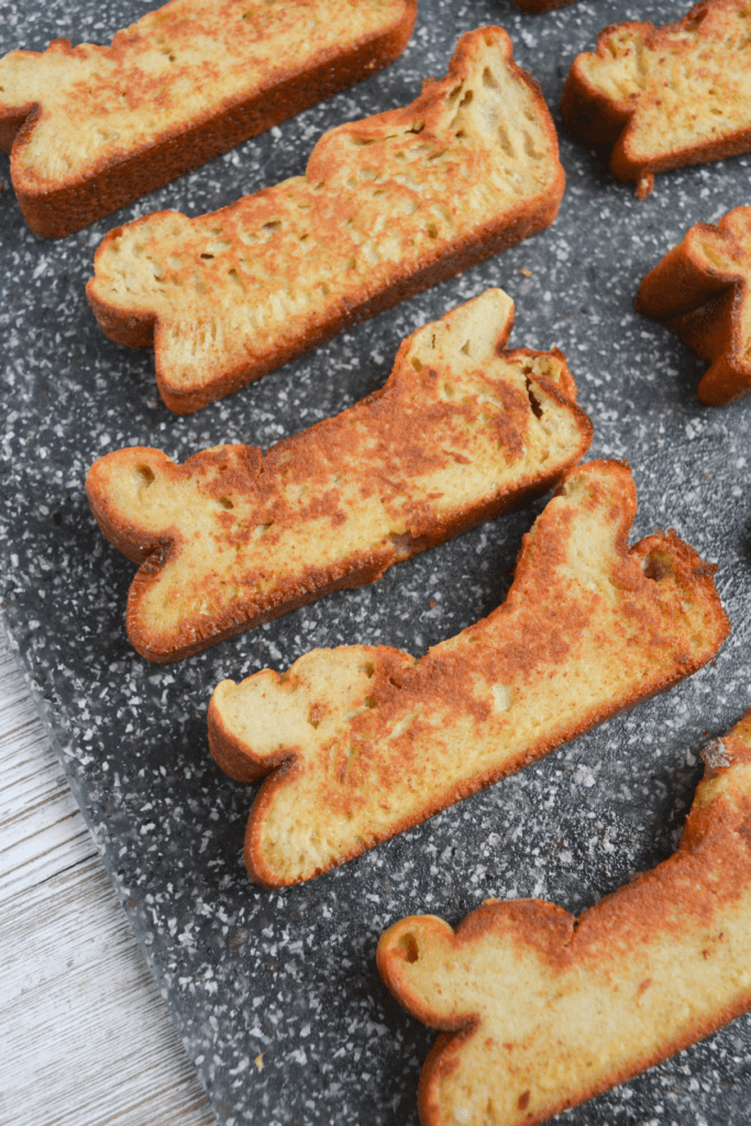 several slices of french toast sticks on a cutting board