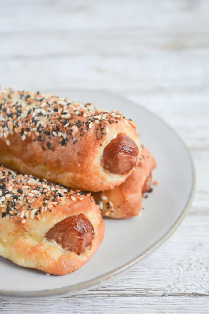 close up on three keto pigs in a blanket on a white plate