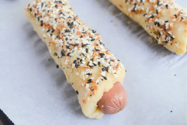 keto pigs in a blanket step 4 - coating dough with seasoning and baking