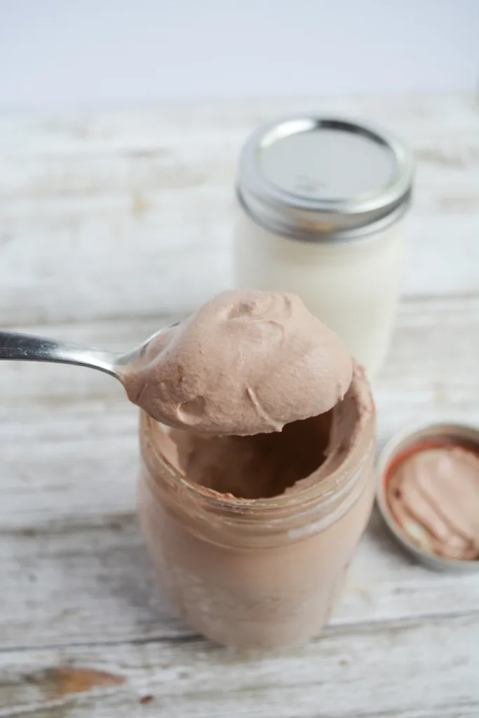 chocolate keto mason jar ice cream with a spoon taking out a creamy scoop
