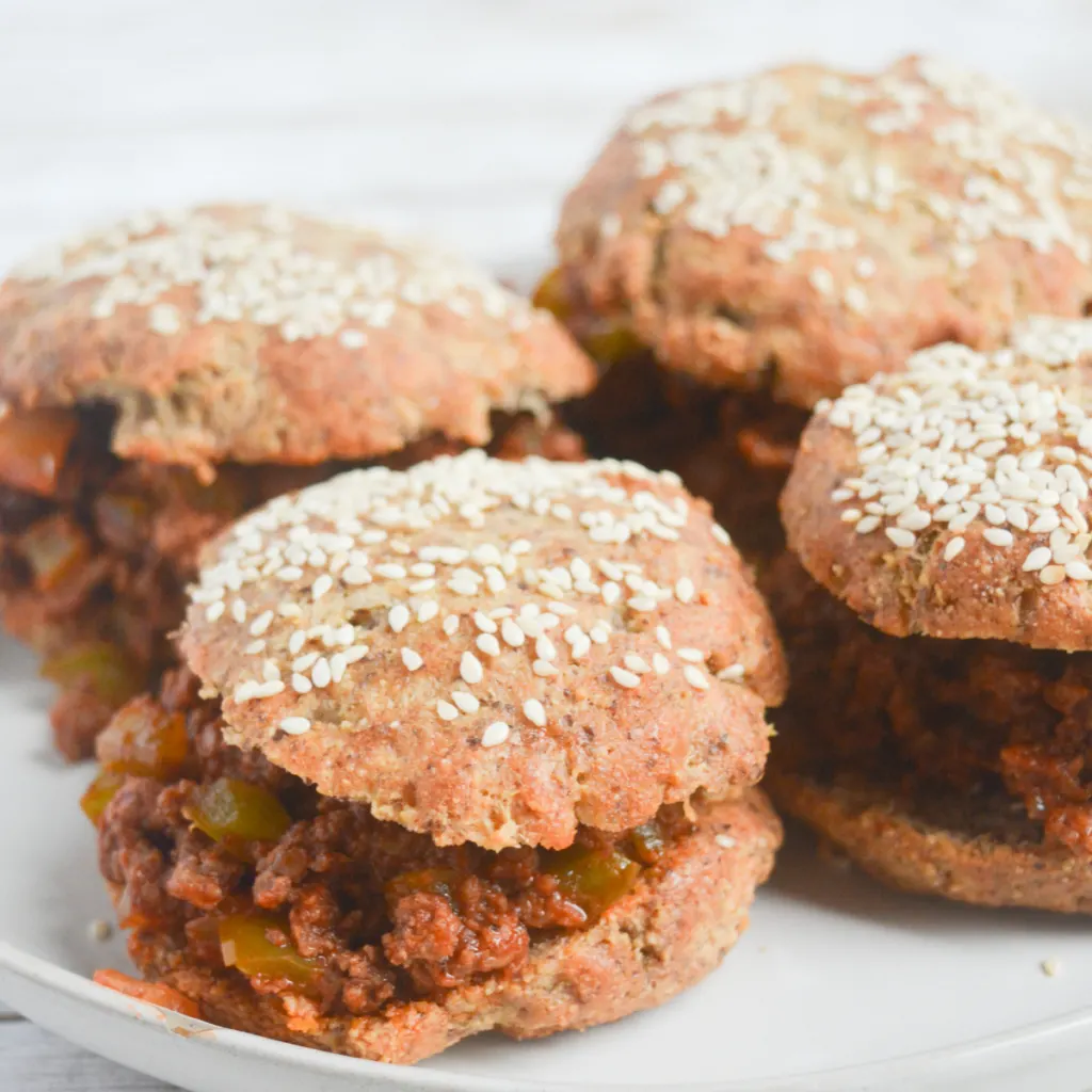 close up on four keto sloppy joes sandwiches with a low carb hamburger bun on each