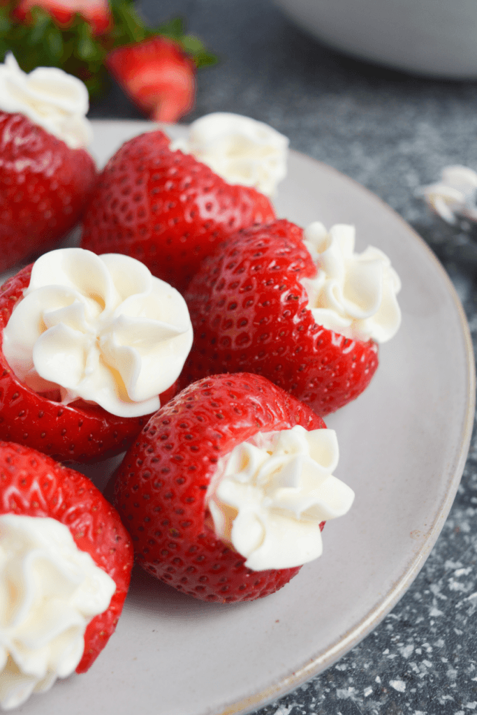 cheesecake stuffed strawberries on a white plate