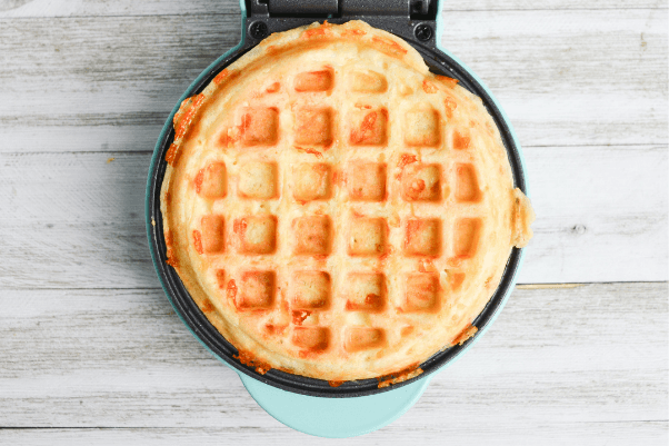 fully cooked chaffle still on the waffle iron