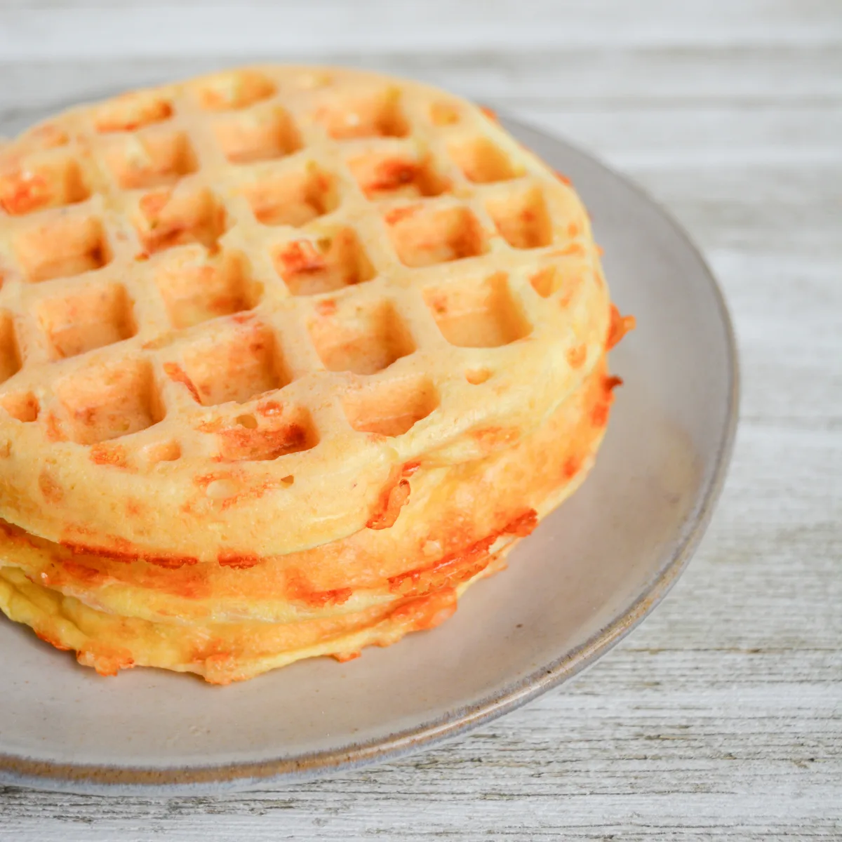 close up of two chaffles stacked on a plate