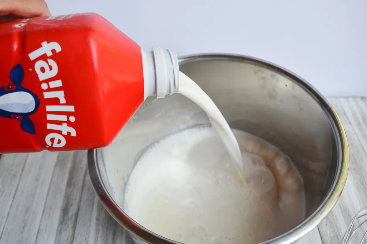 fairlife whole milk being poured into Instant Pot inner pot