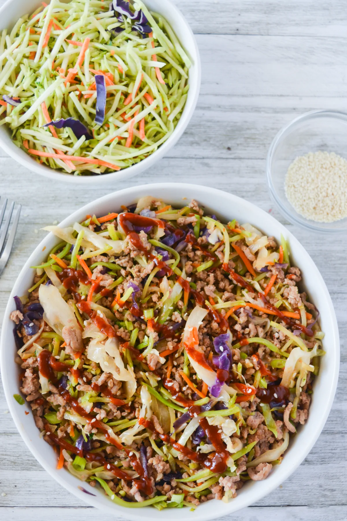 egg roll in a bowl drizzled with sriracha.